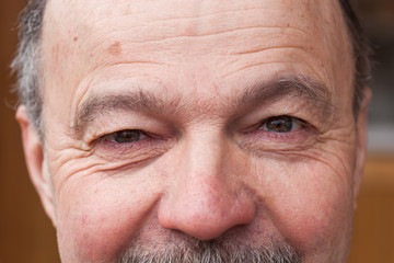 Pensioner looking intently ahead. Tired eyes from life