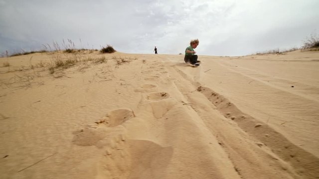 Family spending time together and having fun in Oleshky sands.Ukraine. Slow motion