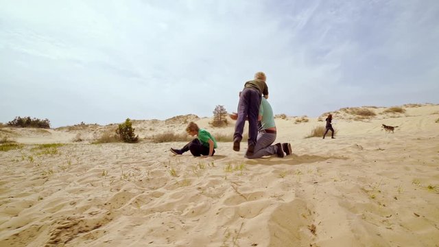 Family spending time together and having fun in Oleshky sands.Ukraine. Slow motion