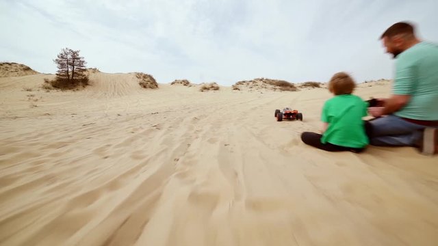 Family spending time together and having fun in Oleshky sands.Ukraine. Slow motion