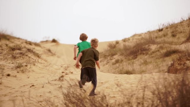 Family spending time together and having fun in Oleshky sands.Ukraine. Slow motion