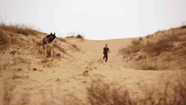 Family spending time together and having fun in Oleshky sands.Ukraine. Slow motion