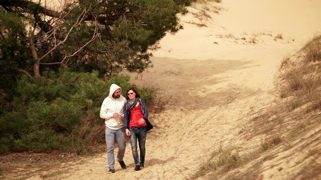 Parets walking together and having conversation in Oleshky sands.Ukraine. Slow motion