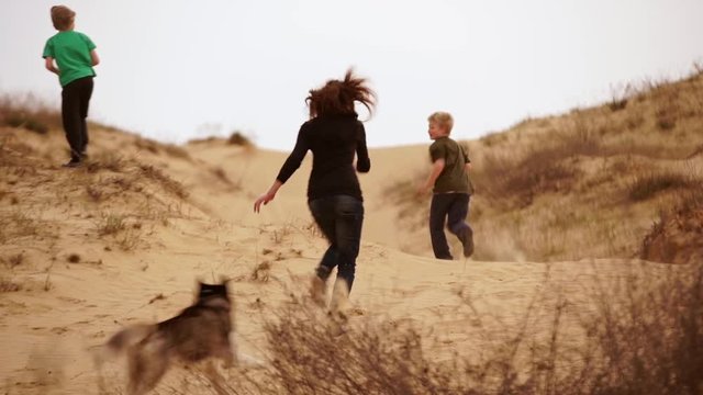 Family spending time together and having fun in Oleshky sands.Ukraine. Slow motion