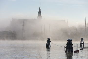 Building at sea in fog