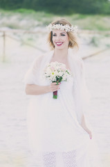 Fototapeta na wymiar Beautiful blond fiancee in white wedding dress