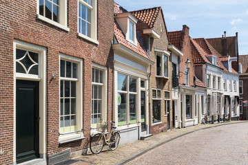 Fototapeta na wymiar Street with row of historic houses in old town of Amersfoort in Utrecht province, Netherlands