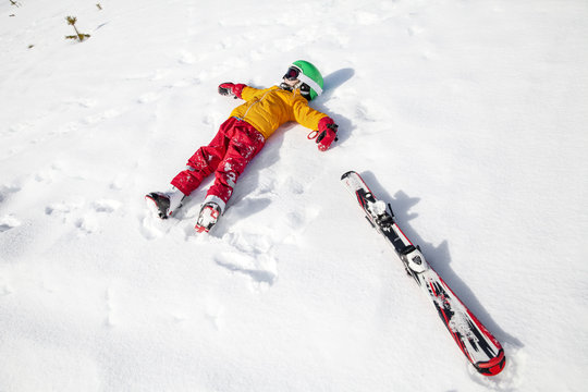 Child on snow with snowboard