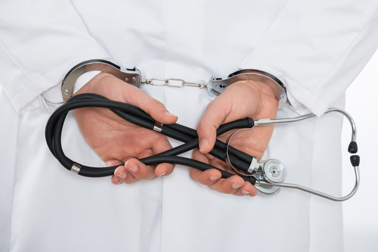 Male Doctor Hands In Handcuffs