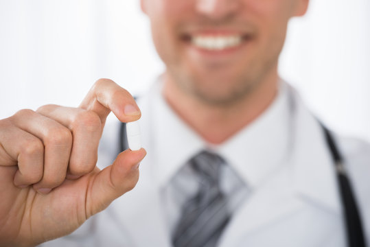 Male Doctor Holding Pill