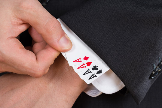 Businessman Removing Ace Cards From Sleeve