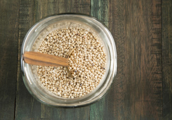 Millo cereal in a glass jar on wooden background