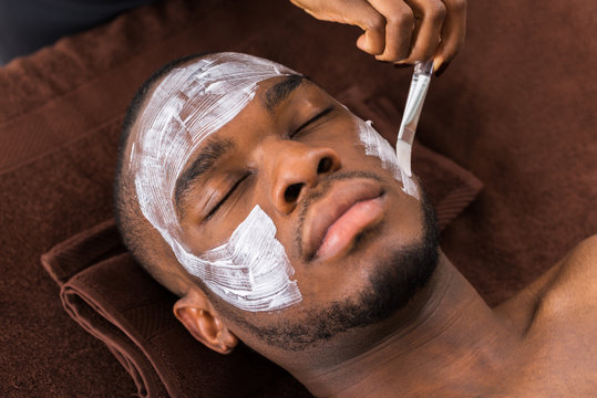 Therapist Applying Face Mask To Man