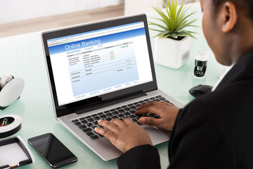 Businesswoman Using Online Banking Service On Laptop