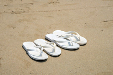 White flip flops on a beach