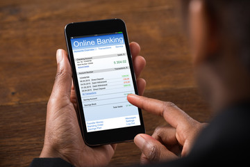Businesswoman Using Online Banking Service On Mobile Phone
