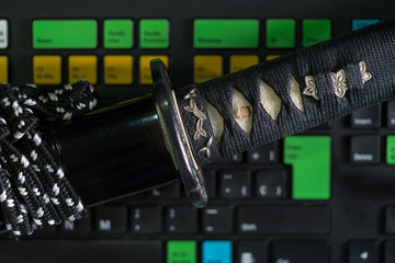 Roped katana against of colorful keyboard buttons