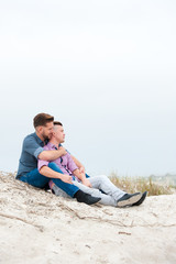 Gay men embracing on a beach