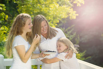 Fototapeta premium Family enjoying the moment outdoors on deck during summer time