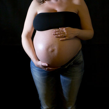 Pregnant on dark background.