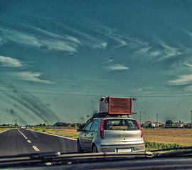 large wooden cabinet on small runabout car