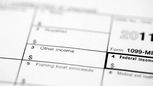 Montage of multiple shots of tax forms, shot with a macro lens for selective focus. Movement is added via a dolly (tracking shots).