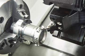 Fototapeta na wymiar metal working. cutting tool pefroming turning operation at cnc machine