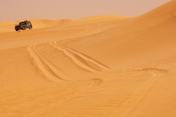 Fototapeta na wymiar Off road car sand dunes safari in the desert
