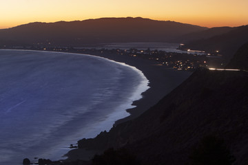 Beach in the coastal town or city on an ocean side at night. Highway 101 or Pacific Coast Highway, California, America.