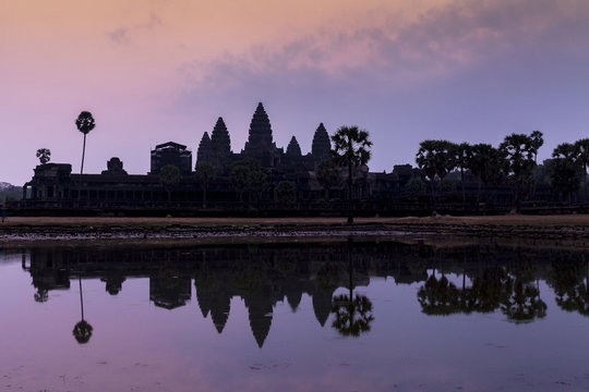 Sunrise in ancient Angkor Wat temple, Siem Reap, Cambodia. Reflection in lake