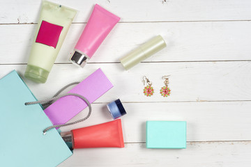 Woman's cosmetics and accessories on wooden background. Beautiful make up bag with cosmetics