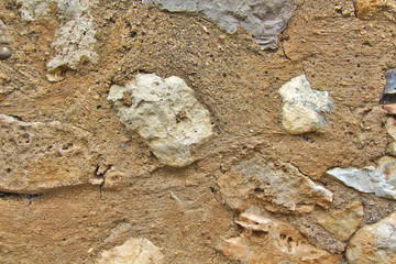 Old grey and brown stone wall in a town