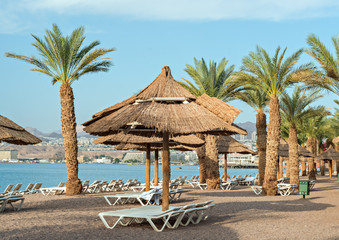 Relaxing facilities on the golden beach of Eilat - famous resort city in Israel