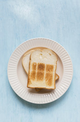 Fototapeta na wymiar White toast on wooden blue table background