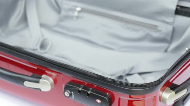 Traveler opening suitcase for packing the cloth, stock video