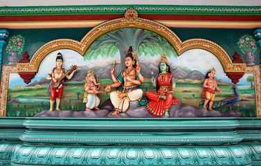 Fototapeta na wymiar The sculptures of Shiva, Parvati and Ganesha in Hindu temple. Kuala Lupmur, Malaysia