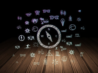 Tourism concept: Compass in grunge dark room