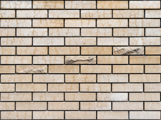 Background. A wall from a yellow brick with three convex bricks