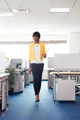 Happy afro american woman walking in office