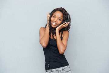 Afro american woman listening music in headphones