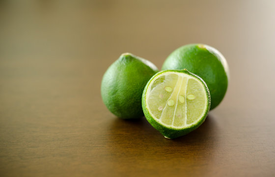 Fresh lime on wooden background