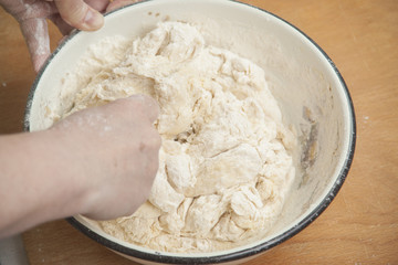 Women's hands preparing fresh yeast dough