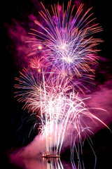 color large fireworks over the water