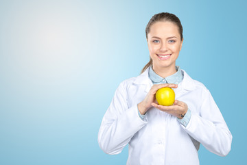 Smiling medical doctor woman with apple