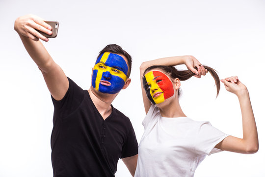 Belgium vs Sweden football fans take selfie photo with phone on white background. European football fans concept.