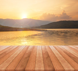 Fototapeta na wymiar wooden table top and beautiful landscape with sunrise or sunset 