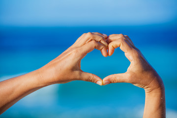 Heart made by female hands 