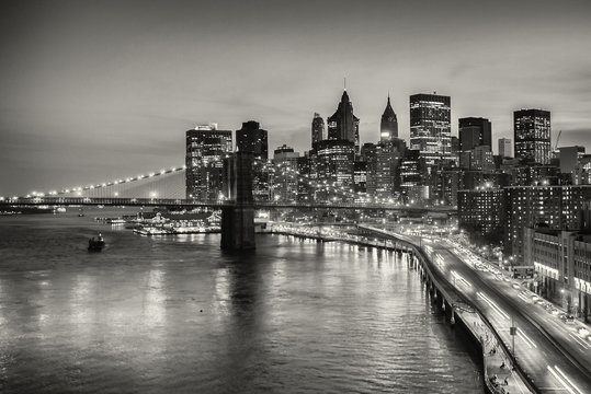 Long exposure of Brooklyn Bridge and downtown Manhattan in New York City - in black and white