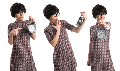 Surprised runette girl holding vintage clock