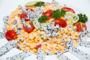  salad of yellow corn seeds in white dish